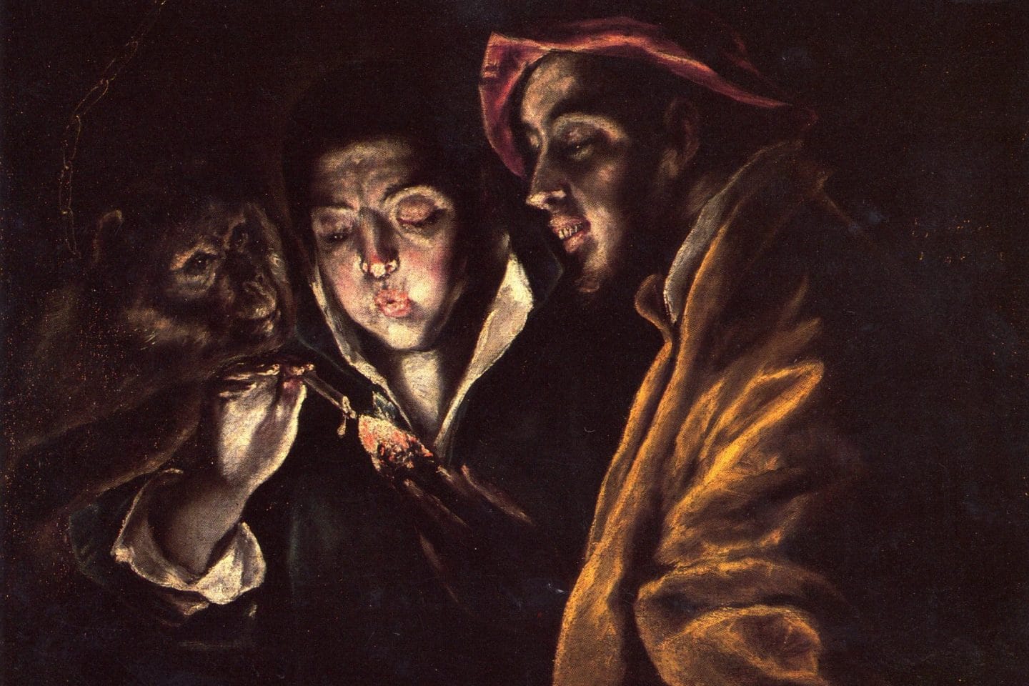 A darkly lit oil picture showing three half-length figures huddled together. The central figure blows on a hot coal, which illuminates the scene. To the left and right stands a chained monkey and a grinning fool.