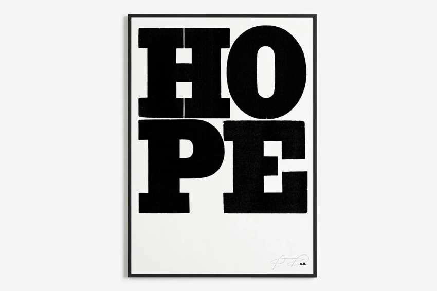 A black and white print (wall art) with the word HOPE written in large text, signed by Anthony Burrill.