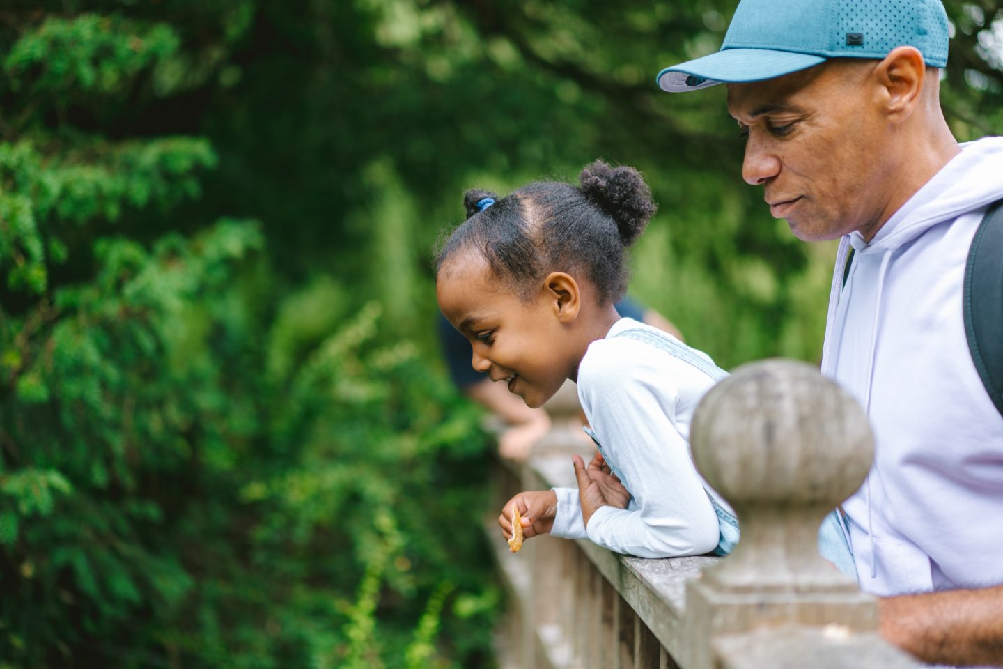 Young girl and adult looking at the wildlife below the bridge in the Himalayan Garden.