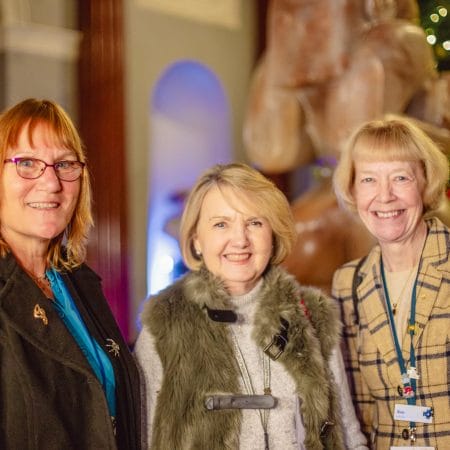 Three fabulous women smile towards the viewer celebrating Christmas at Harewood.