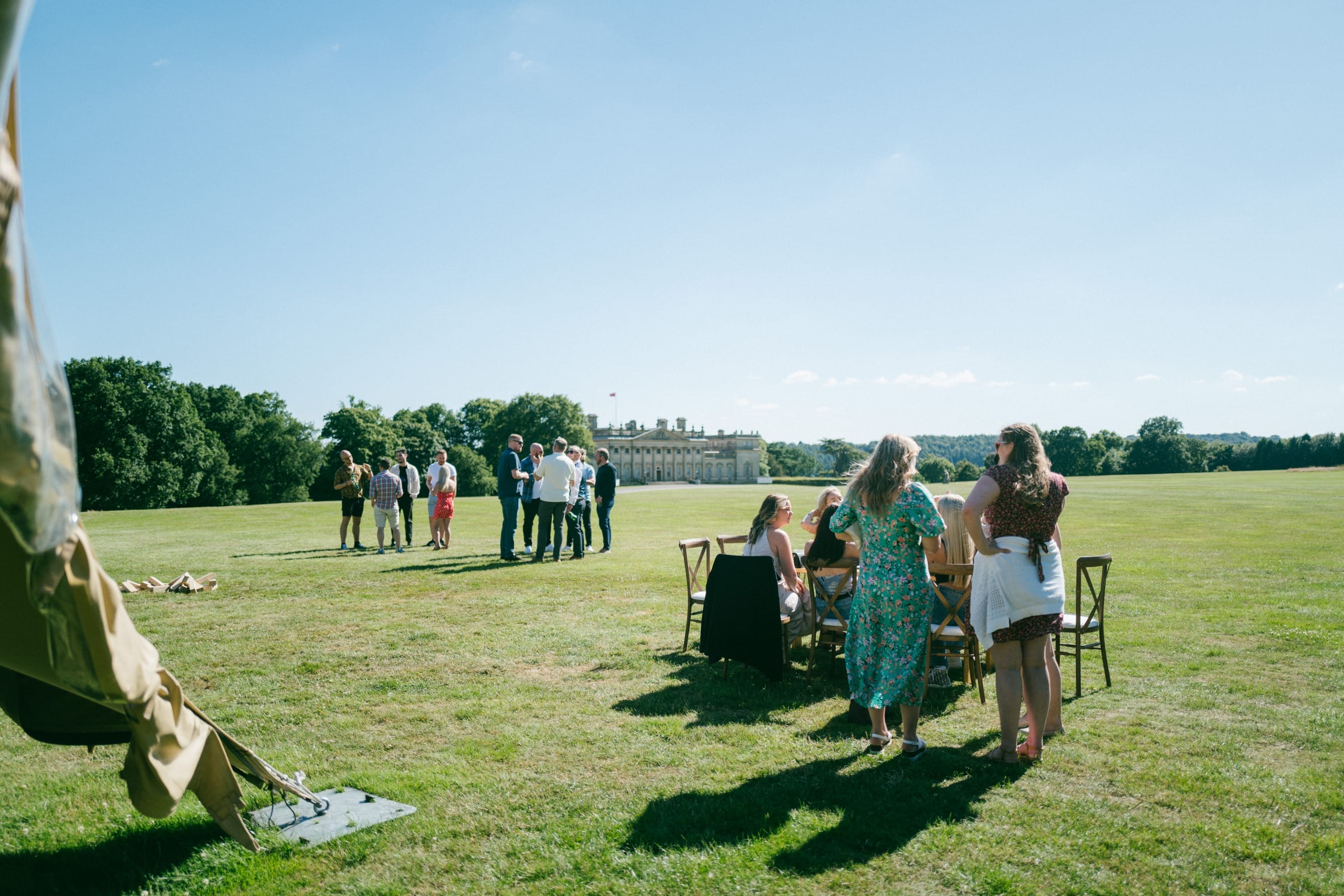 A group of people enjoy a staff away day at Harewood on a late summers evening. They play games on the North Front lawn outside Harewood House, drinking and enjoying time togeher.