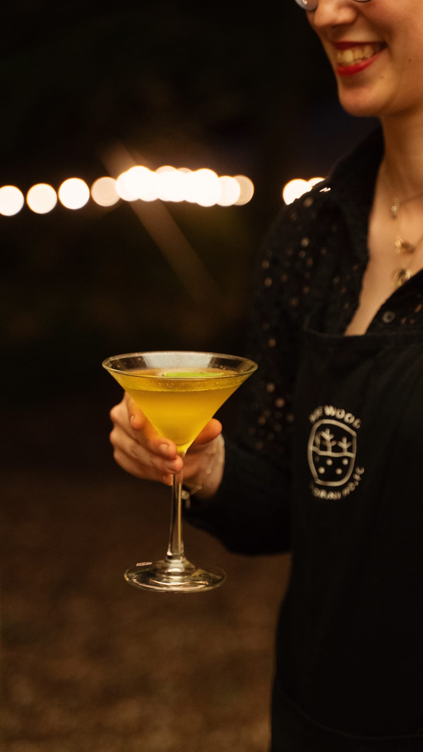 Harewood food and drink project staff member carries a drink in a martini glass